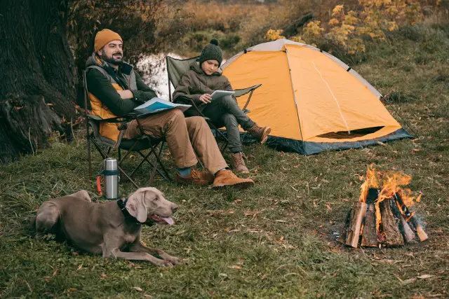 Couple camping with their dog